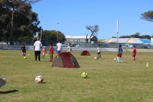 FS4 players training with pop-up goals and cones on the field