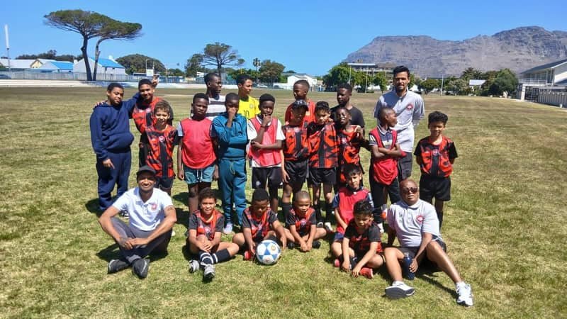 FS4 squad and coaches group photo with the Cape Town mountains behind them